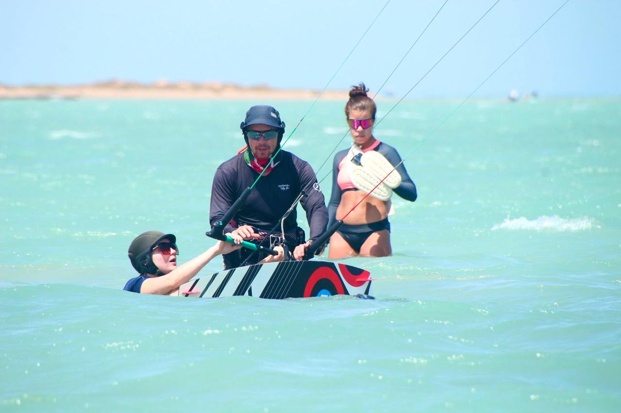 Kite instructor explains to a student how to waterstart